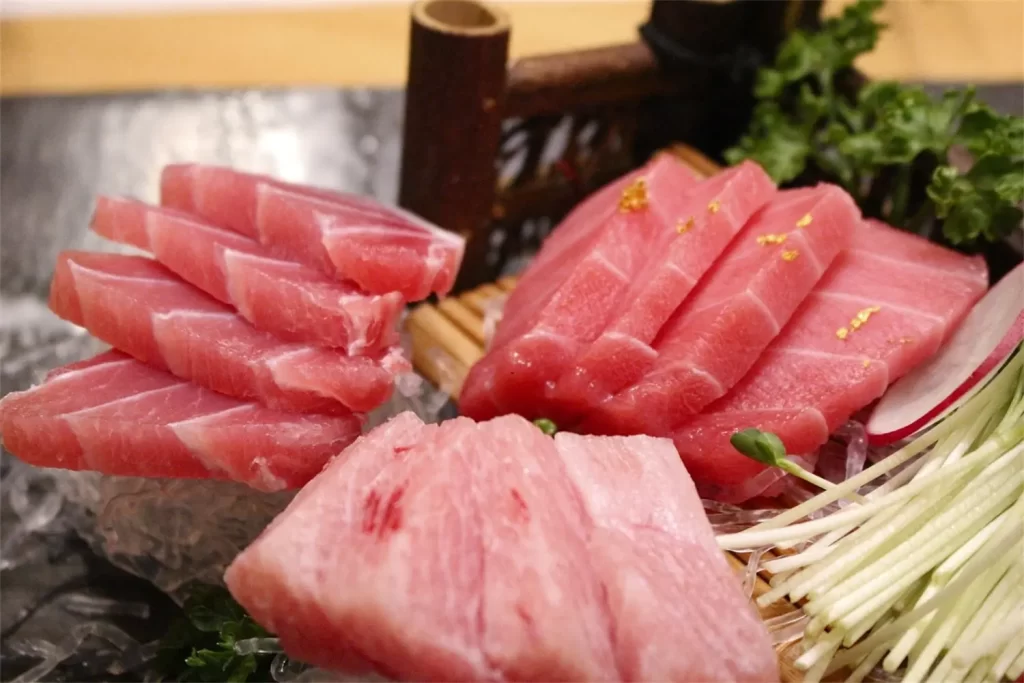 Premium tuna sashimi served on ice garnished at Otoro Sushi & Ramen, a Sushi Restaurant in Omaha